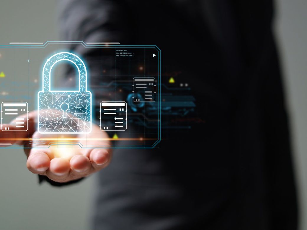 Hand holding a glowing digital padlock icon